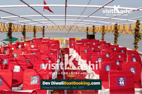 Rows of red seats and marigold decorations aboard a Dev Diwali boat
