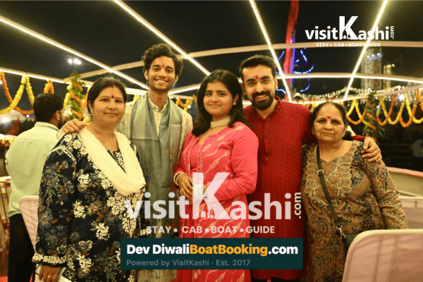 Family posing together on a decorated boat at night